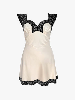 White dress with black lace details on a white background
