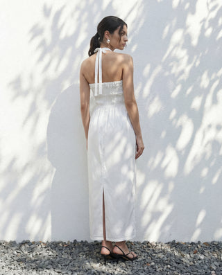 Back view of Sylvie halter dress in White with shirred back
